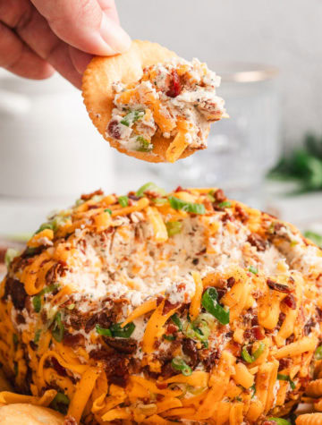 ritz cracker dipped in bacon ranch cheese ball