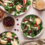 bowls of salad with mixed greens and apples and pecans